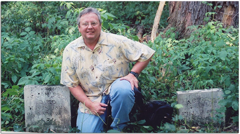 Gary next to headstones